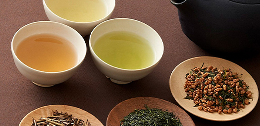 緑茶、玄米茶などの茶葉を入れた小皿3つと、それぞれのお茶を入れた湯呑3つ、急須